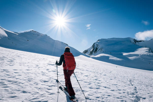 istock Ski mountaineer ascends snowy mountain ridge line 1208659272