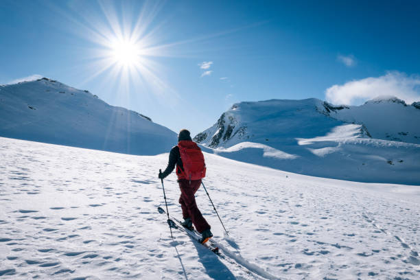istock Ski mountaineer ascends snowy mountain ridge line 1208659276