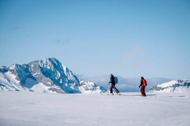 istock Ski mountaineers ascend snowy mountain ridge line 1208659479