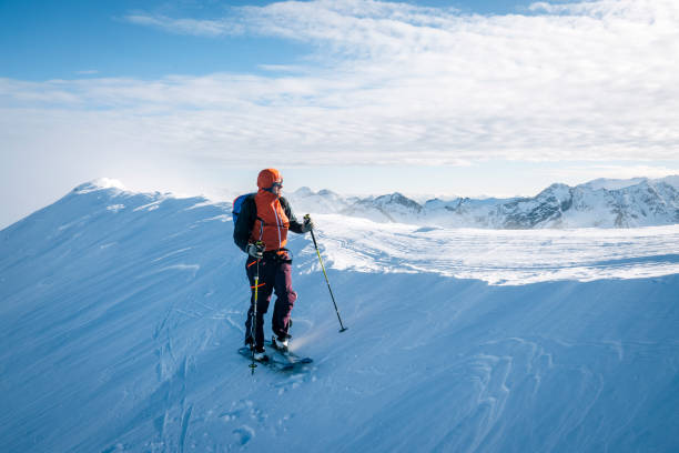 istock Ski mountaineer ascends snowy mountain ridge line 1208659565