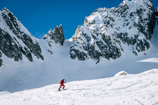 istock Ski mountaineer ascends snowy mountain ridge line 1208659637