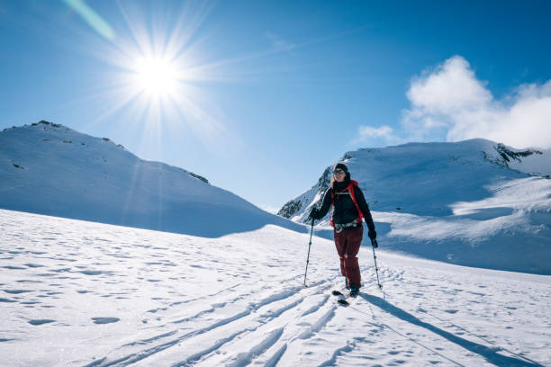 istock Ski mountaineer ascends snowy mountain ridge line 1208659657