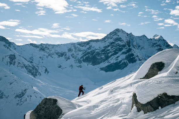 istock Ski mountaineer ascends snowy mountain ridge line 1208659686