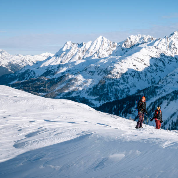 istock Ski mountaineer ascends snowy mountain ridge line 1208659699