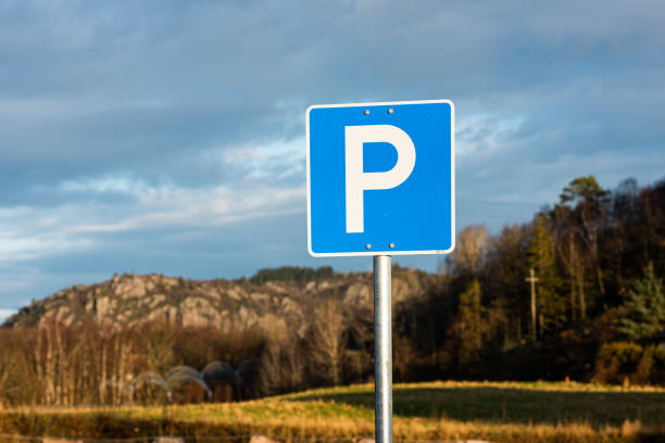 istock Parking allowed sign. Trees and mountains in the background. 1208660387
