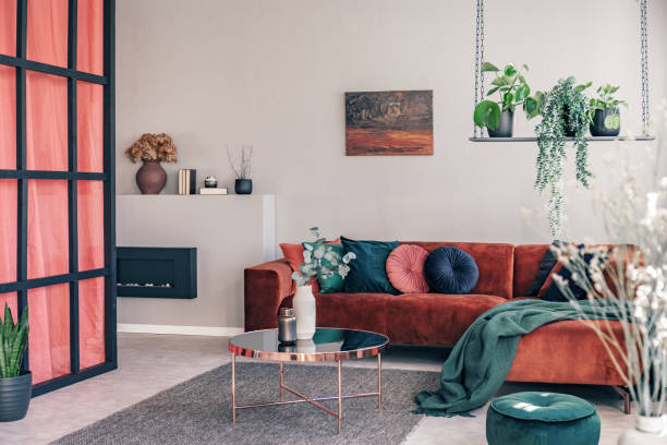 istock Pillows and blanket on modern sofa in bright living room interior 1208661687
