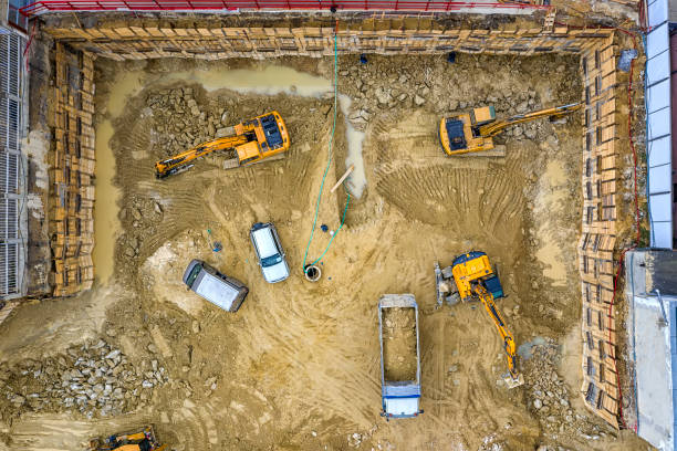 Heavy construction equipment Heavy construction equipment working at the construction site. Aerial view from drone archaeology stock pictures, royalty-free photos & images