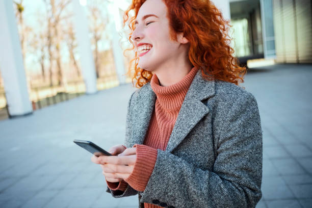 istock Caucasian redhead businesswoman sanding sms smiling 1208666791
