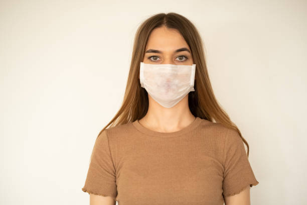 istock young woman with protection mask 1208670053