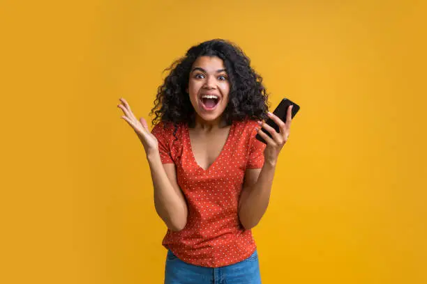 Photo of Portrait of attractive young african american girl using mobile phone