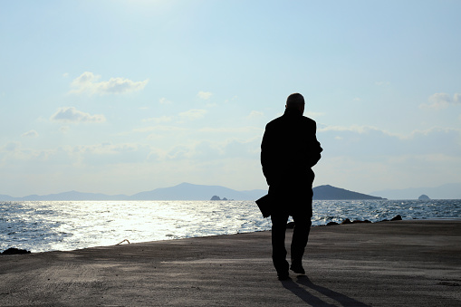 A man looking at the sea alone