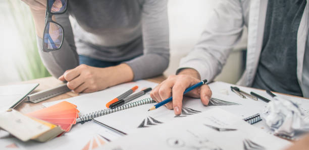 istock Graphic designer drawing sketches logo design. 1208672876