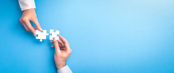 People holds in hand a jigsaw puzzle. Business solutions, success and strategy.