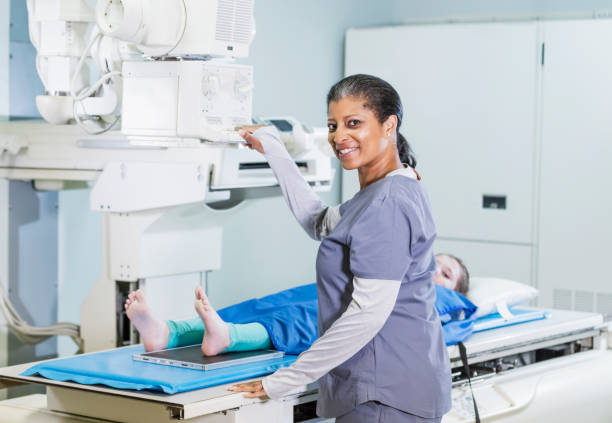 Technologist taking x-ray of girl's foot