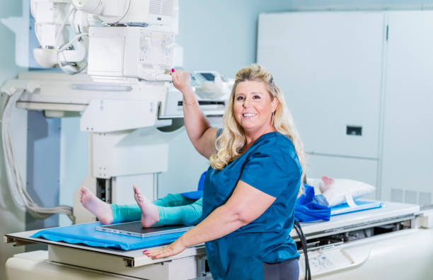 istock Technologist taking x-ray of girl's foot 1208674254