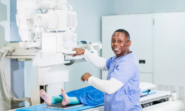 istock Technologist taking x-ray of girl's foot 1208674301
