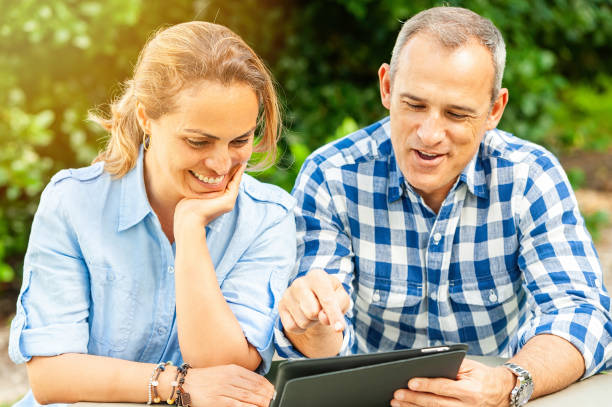 istock Happy hispanic mature couple looking at their digital tablet 1208676539