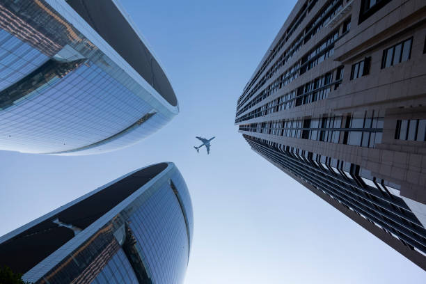 istock A plane flies over a commercial building 1208677765