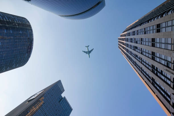 istock A plane flies over a commercial building 1208677773