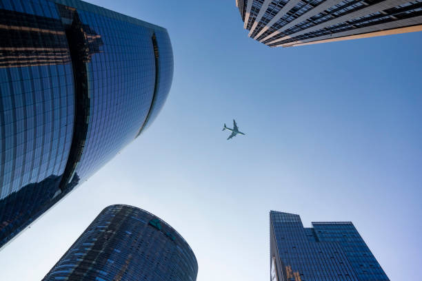 istock A plane flies over a commercial building 1208678832