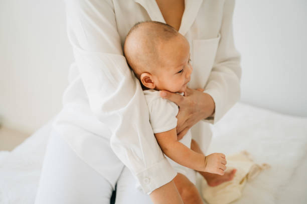 Mom with Asian baby on legs