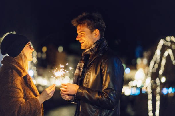 istock Happy couple holding sparkling sticks 1208683447