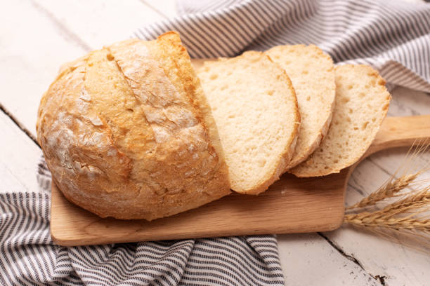 istock Fresh bread on wooden table. Top view with space for your text 1208683674