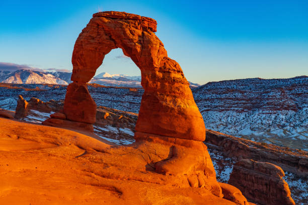 istock The Setting Sun Illuminates Delicae Arch 1208690702