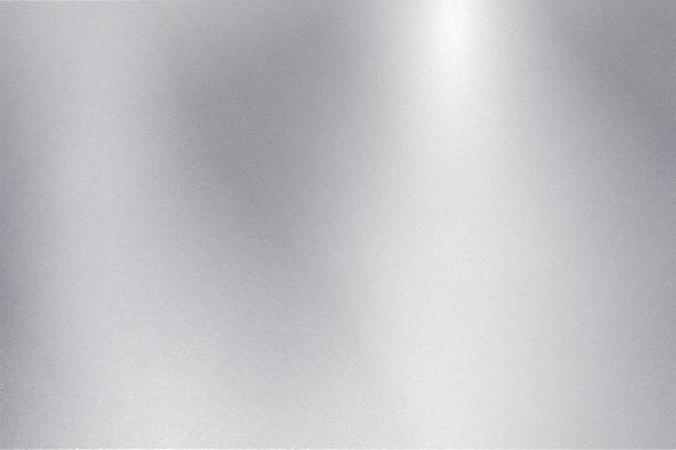 istock Light shining down on silver foil metallic wall with copy space, abstract texture background 1208692531