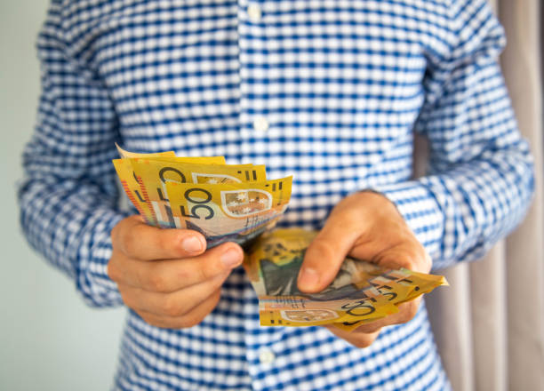 Man handling fifty dollar notes finance. Man handling fifty dollar notes finance. Money and bills economy australian dollar stock pictures, royalty-free photos & images