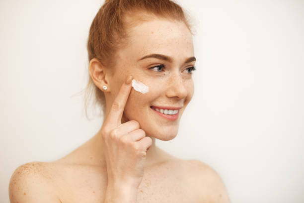 https://media.istockphoto.com/id/1208699158/photo/lovely-caucasian-girl-with-red-hair-and-freckles-is-smiling-while-using-a-cream-on-her-face.jpg?s=612x612&w=0&k=20&c=THyaNABZNHx_OEDGWb70HXhJ96fKUUHqNEd01apK7-4=