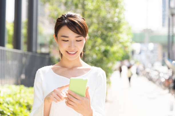istock asian woman who see a smart phone 1208700021