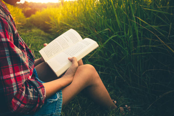 istock Women read book in quiet prairie green, concept read a book. 1208701188