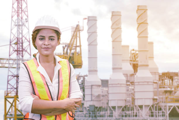 istock mixed race woman engineer staff worker and offshore rig background concept. 1208704333