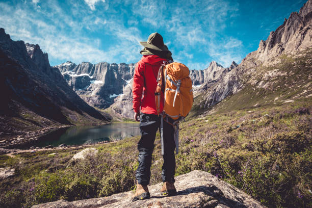 istock Woman hiker hiking on high altitude mountains 1208704336