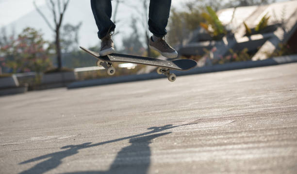 istock Skateboarder skateboarding at sunrise park 1208704464