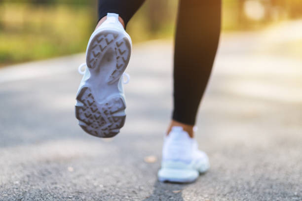 istock a woman's legs while jogging in city park in the morning 1208710251