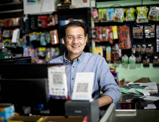 happy male cashier at supermarket - asian ethnicity shopping mall supermarket store imagens e fotografias de stock