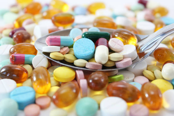 istock Various colorful medicine drugs, pills, capsules on spoon 1208720113
