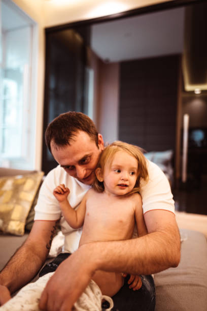 istock dad dressing up the daughter 1208720946