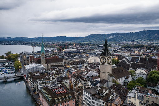 aerial view of St. Peter's Church clock tower and Fraumunster by the Limmat River, Zurich old town.
