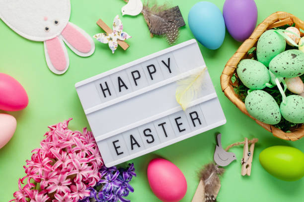 istock Easter background with  hyacinth flowers, colored eggs and decorations on color background with text 