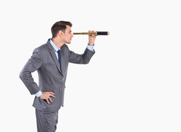 istock Businessman looking through spyglass 1208725538