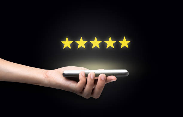 istock Customer Experience Concept, Hand man holding a smartphone with five star excellent rating 1208726150