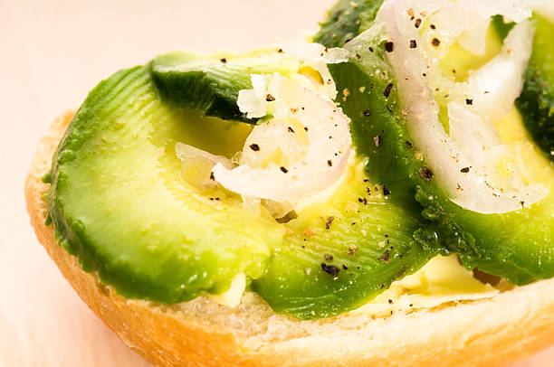 Sandwich with avocado on a wooden board