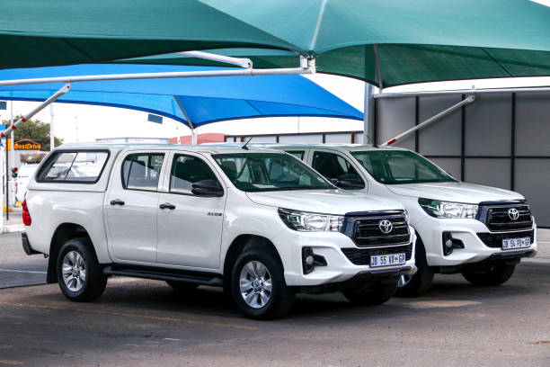 Toyota Hilux Hosea Kutako International Airport, Namibia - February 5, 2020: Rental cars Toyota Hilux at the airport parking. toyota hilux stock pictures, royalty-free photos & images