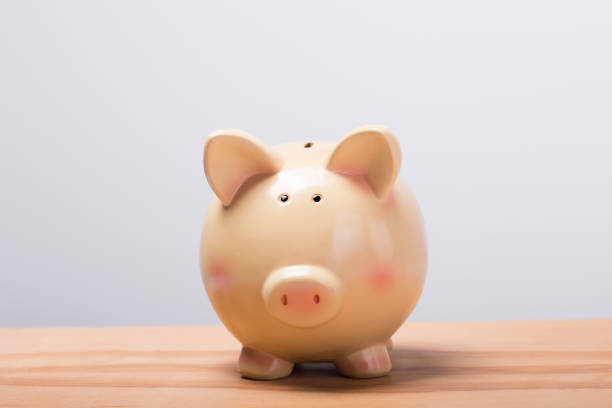 istock Piggy bank on wooden table 1208735363