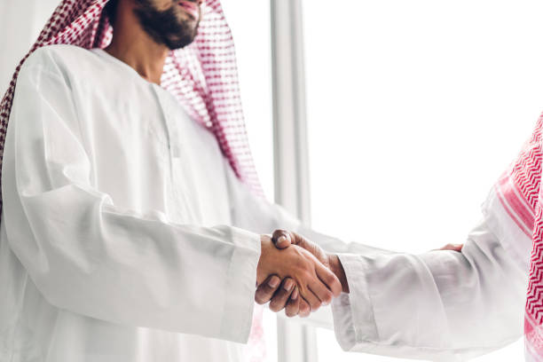 Successful of arab business partner handshake together in modern office.Partnership approval and thanks gesture concept stock photo