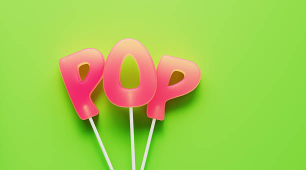 Pop written by pink letter shaped lollipops on green background. Horizontal composition with copy space. Music genre concept.