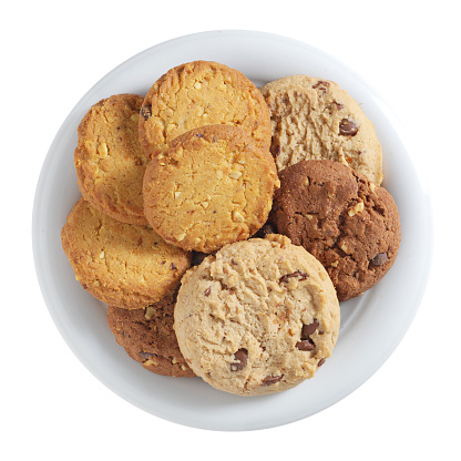 Various cookies in plate isolated on a white background, top view